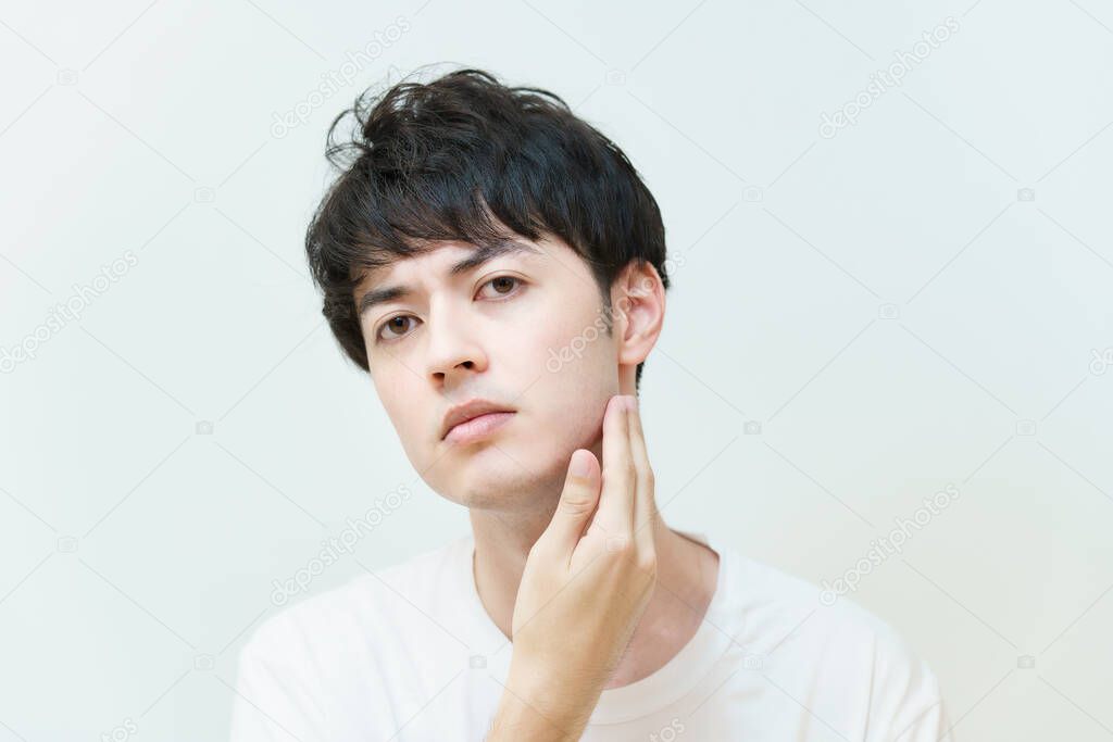 Asian young man checking skin condition