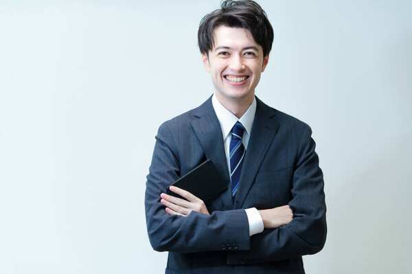 Asian young businessman posing with his arms crossed