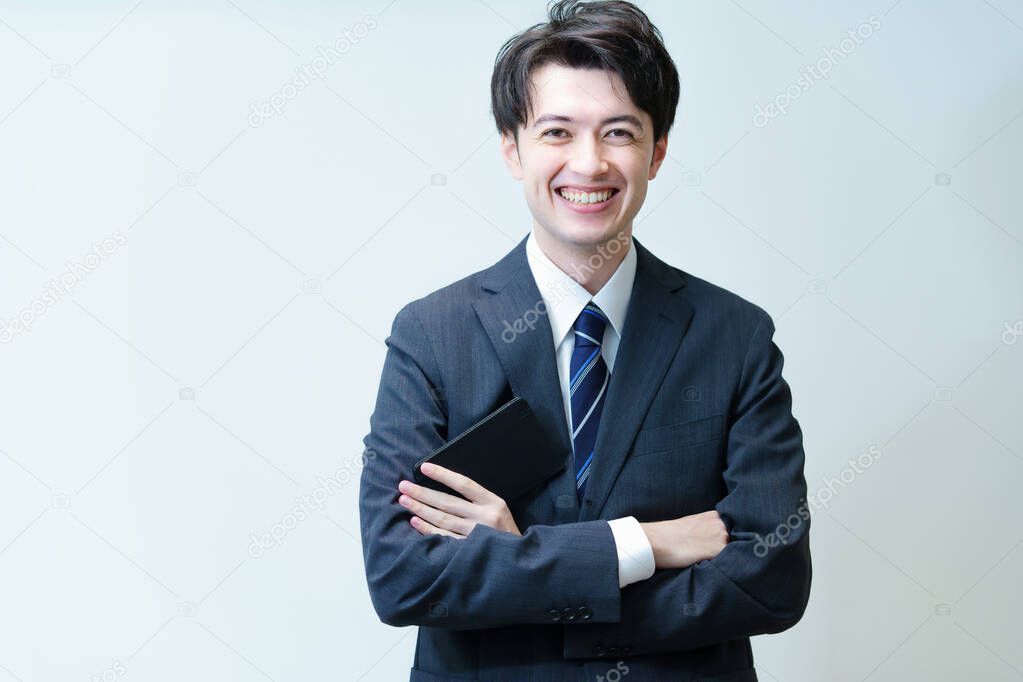Asian young businessman posing with his arms crossed