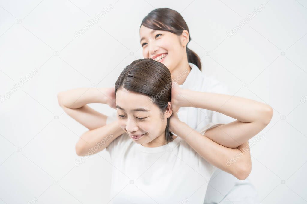 Asian young woman receiving a massage at an esthetic salon