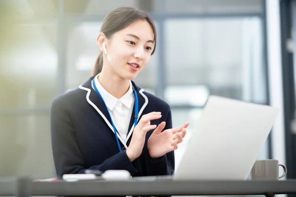 アジアの若い女性がコンピュータの画面に話している — ストック写真