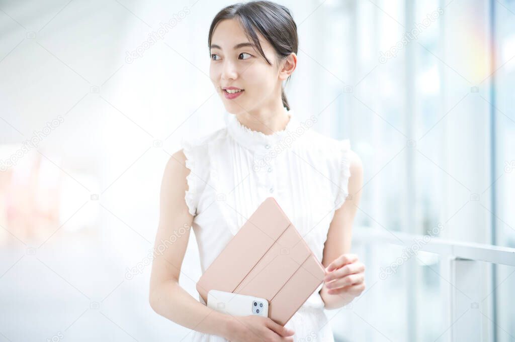 Young business woman or female college student by the window