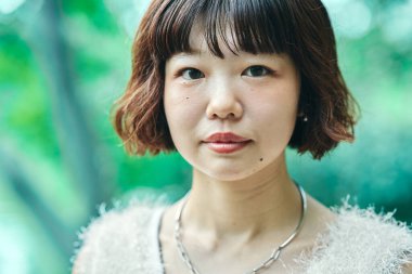 Young Asian woman taking a walk on fine day