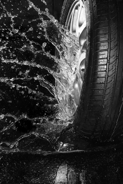 New summer tire  with water spra — Stock Photo, Image