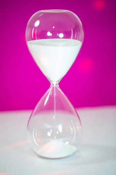 Hourglass on a pink background, Corona, New Year