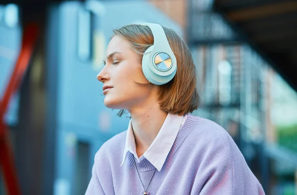 Melancólica estudiante de auriculares escucha música —  Fotos de Stock