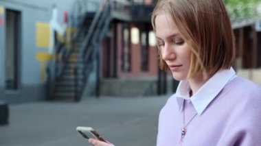 Açık havada akıllı telefon kullanan kız öğrencinin portresi