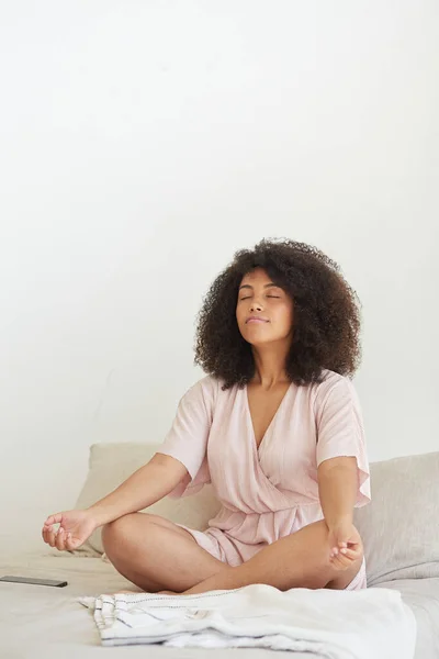 Young happy mixed race woman practicing yoga and doing breathing exercises. — Stock Photo, Image