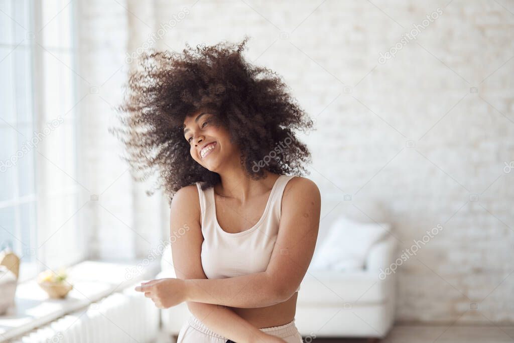 A satisfied mixed-race woman enjoys rhythmic movement