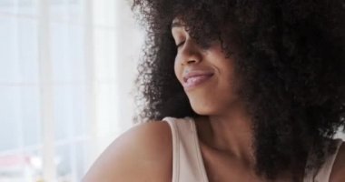 Mutlu, neşeli, melez bir kadın yalnız dans ediyor.