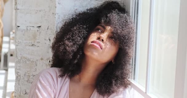 View of a thoughtful melancholic lonely young black woman breathing with closed eyes — Stock Video