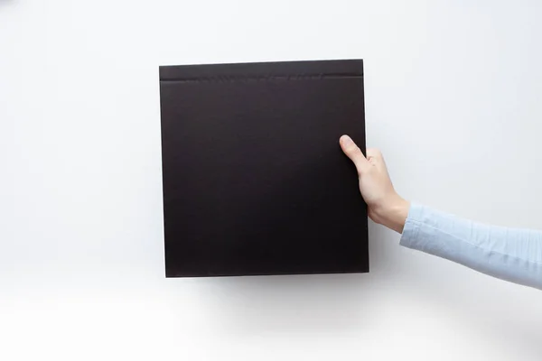Hands Hold Black Sheet Empty Space Label — Stock Photo, Image