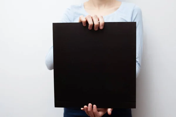 Hands Hold Black Sheet Empty Space Label — Stock Photo, Image