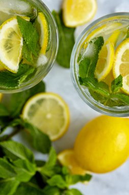 Yaz için ferahlatıcı içecekler, dilimlenmiş taze limonlu soğuk tatlı ve ekşi limonata suyu. Tazeleyici yaz içeceği. Limonlu, naneli ve buzlu geleneksel limonata. Seçici odak