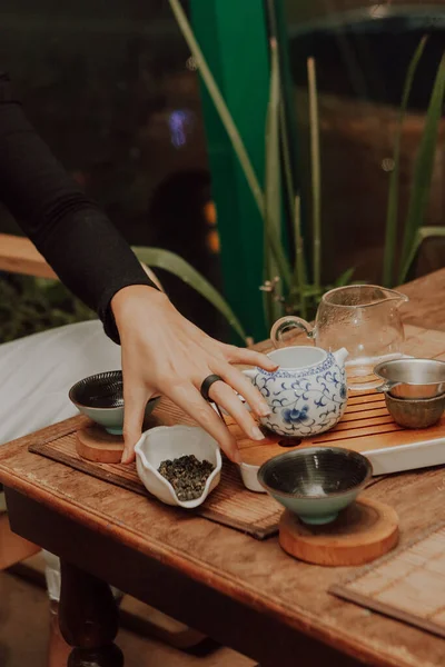 Woman serving Chinese tea in a tea ceremon