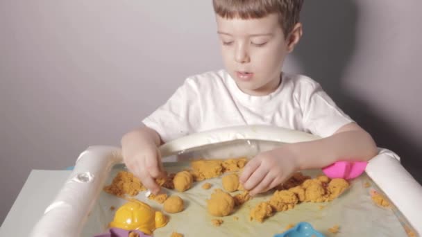 Beyaz Masa Oturan Evde Kinetik Kum Oynayan Bir Çocuk Beyaz — Stok video