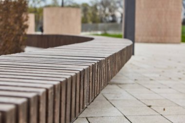 Banklı güzel bir park. Yeşil parktaki boş bank ve güneşli gökyüzü, açık yeşil park. Yeşil parktaki banklar, hiç kimse. Yaz turizmi ve seyahatler, turistler için popüler yerler