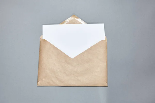 White Paper Sheet Mockup Brown Craft Envelope Gray Background White — Stock Photo, Image