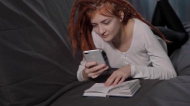 Genç ve güzel bir kadın evdeki kanepede uzanıyor ve kitap okuyor. Bir kadın telefona cevap vermek için okumayı yarıda kesiyor. Rastalı kızıl saçlı bir kız evde dinleniyor.