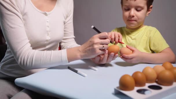 Boy Mom Paints Easter Egg Table Blue Background Little Boy — Vídeos de Stock
