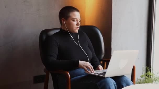 Een Jong Meisje Met Hoofdtelefoon Met Kort Haar Een Neuspiercing — Stockvideo