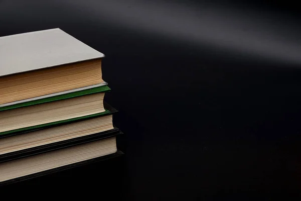 Stack of colorful books. An open book on a stack of books. The concept of education, international book day, success. Book, hardback colorful books on table. Education business concept.