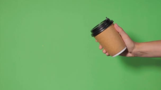 Close Green Background Woman Hand Holds Paper Cup Coffee Stand — Stock Video