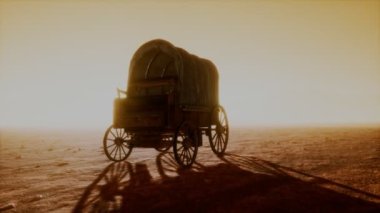 Çölde gün batımında eski arabaları kaplayan tuval.