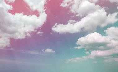 Soyut pembe gökyüzü ve beyaz tüylü kümülüs bulutları. Gökyüzünde ışıldayan güneş ışınları. Yaz mevsiminde bulutların yumuşaklığı. Açık hava çevre arka planında iyi hava