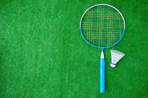 Two badminton mini rackets with white shuttlecock on the green background, active games. copy space.