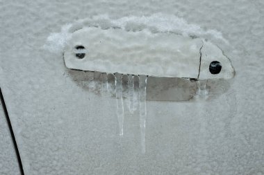 Frozen car door closeup, icicles, ice crystals, jammed lock. clipart