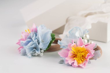 On a light background, a blurred image of a hair tie, in the background a box.Photo with bokeh effect.