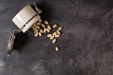 Beyaz seramik kavanoz, içinde fındık ve fındık var.