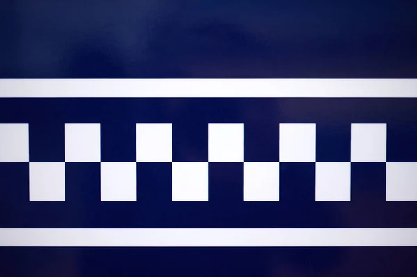 detail of white and blue squares with white lines on a blue background