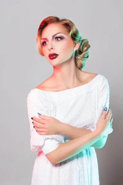 Beautiful young blond woman in elegant white dress, studio shot — Stock Photo, Image