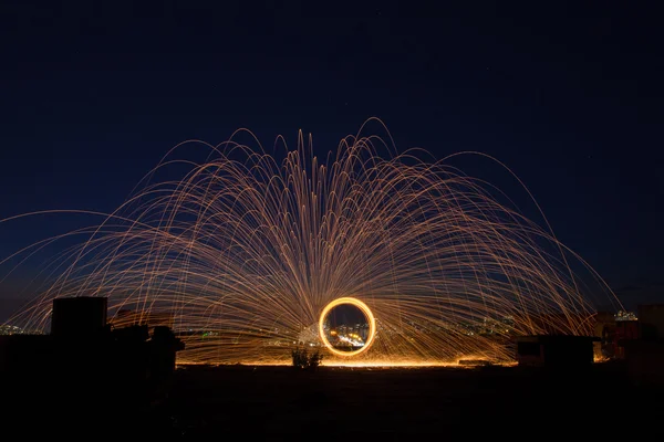 Beautiful sparkle sparklers in a circle on a black background — Stock Photo, Image