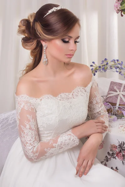 Beauty woman with wedding hairstyle and makeup. Bride fashion. Jewelry and Beauty. Woman in white dress,perfect skin. Girl with stylish haircut.