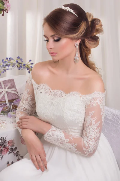 Beyaz arka planda moda düğün saç stili olan güzel bir gelin. Yakından güzel bir gelinin portresi. Düğün için. Stüdyo fotoğrafı. Yüzünde peçeyle güzel bir gelin portresi.