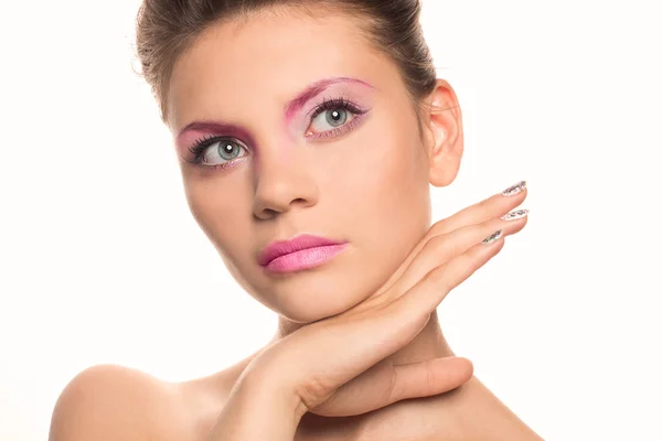 Beautiful Woman Touching her Face. Creativ pink makeup. Perfect Fresh Skin. Beauty brunette Model. Youth and Skin Care Concept. Studio shot. Isolated on white background — Stockfoto