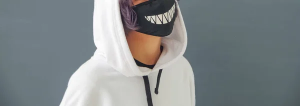 young woman in white hood and black protective mask, virus protection concept