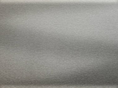 Fırçalanmış alüminyum arka plan veya doku. Soyut doku arka planı, gri metal duvarda parlayan ışık.