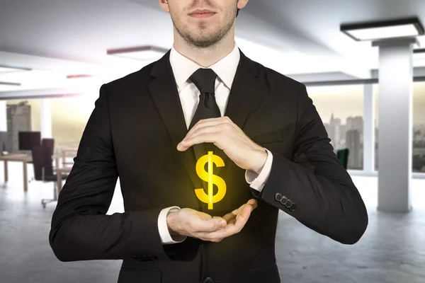 Businessman protecting golden dollar symbol — Stock Photo, Image