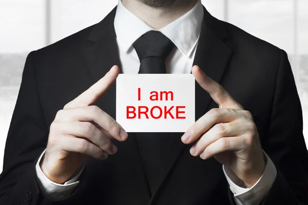 Businessman holding sign i am broke — Stock Photo, Image