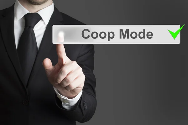 Businessman pushing button coop mode green checked — Stock Photo, Image