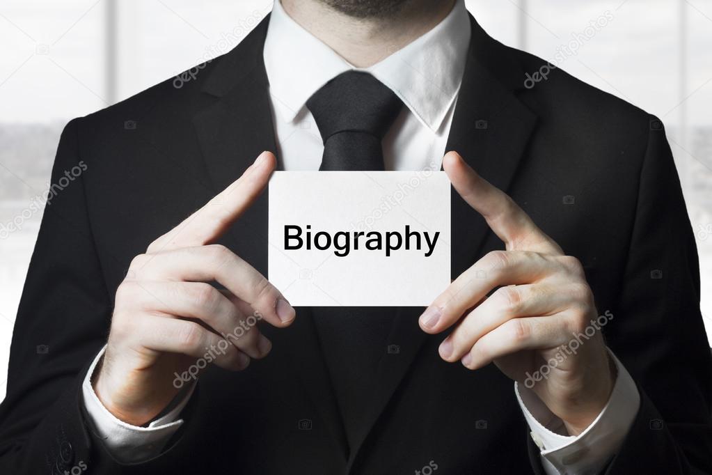 Businessman holding sign biography