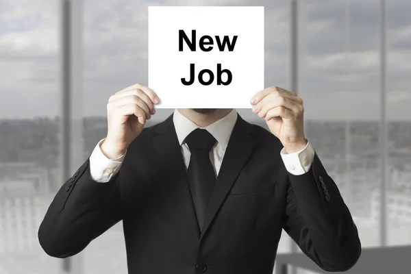 Businessman hiding face behind sign new job — Stock Photo, Image