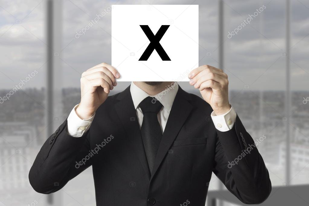Businessman hiding face behind sign crossed out