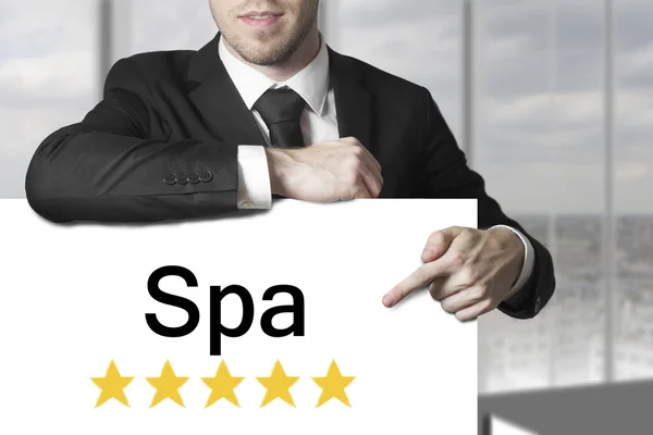 Homme d'affaires pointant sur signe spa étoiles d'or — Photo