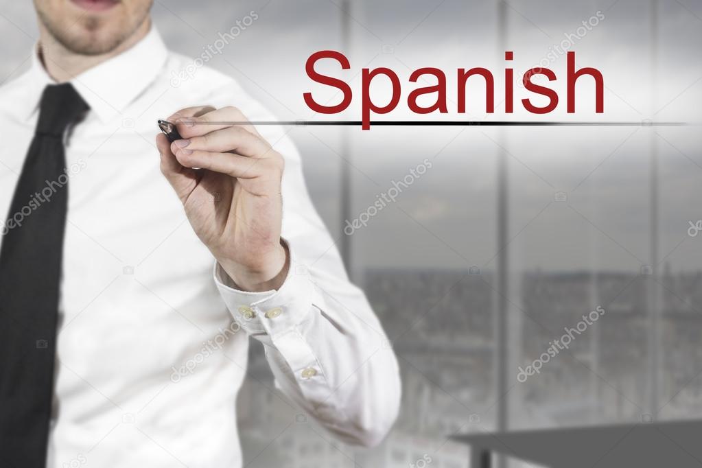 businessman writing spanish in the air