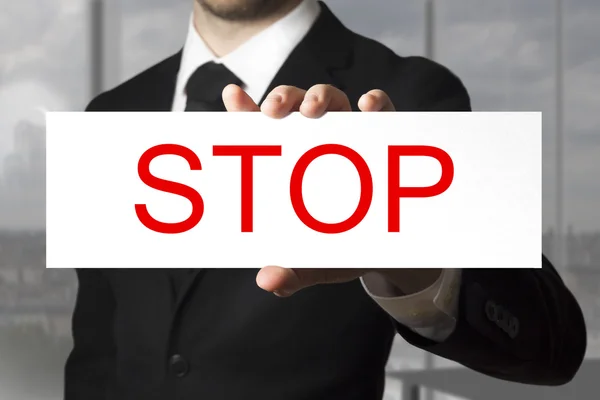 Businessman holding sign stop — Stock Photo, Image